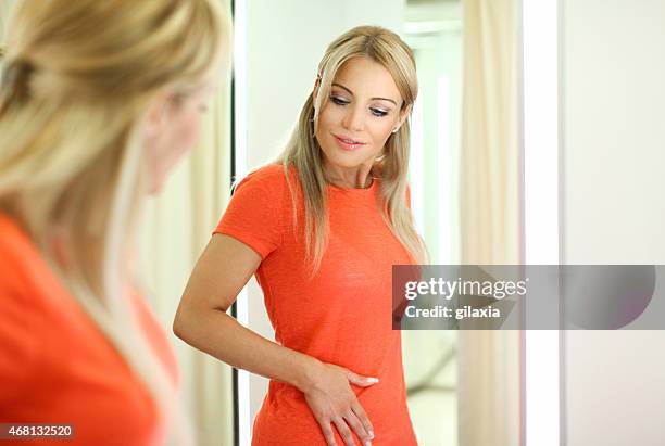 new dress fits perfectly - orange dress stock pictures, royalty-free photos & images