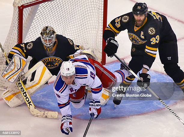 The Bruins' Zdeno Chara clears the Rangers' Jesper Fast from the front of the Bruins net in the third period, as Bruins goalie Niklas Svedberg has a...