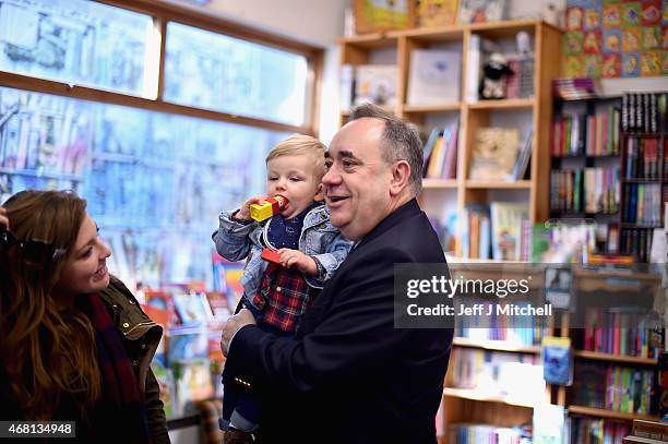 Candidate for the Gordon constituency Alex Salmond holds a child during the first day of the British General Election campaign on March 30, 2015 in...