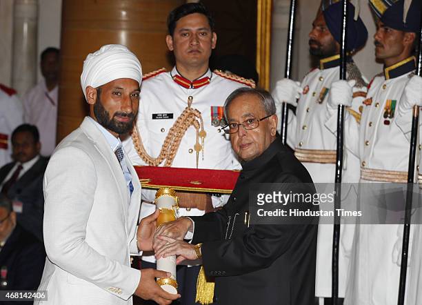 President Pranab Mukherjee presents Padma Shri award to Indian mens hockey team captain Sardar Singh during a Civil Investiture Ceremony at...