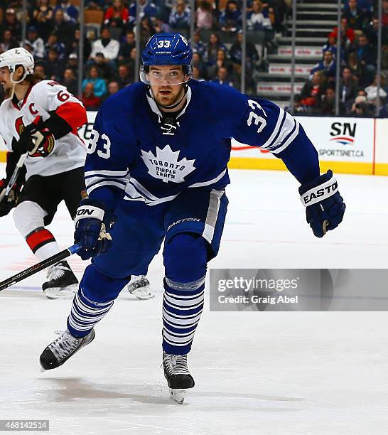 Tim Erixon of the Toronto Maple Leafs skates up the ice against the Ottawa Senators during game action on March 28, 2015 at Air Canada Centre in...