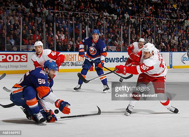 Johnny Boychuk of the New York Islanders blocks a shot by Stephen Weiss of the Detroit Red Wings at the Nassau Veterans Memorial Coliseum on March...