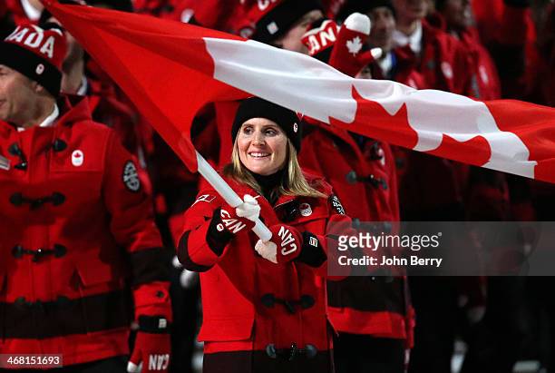 Hayley Wickenheiser is the flag bearer for Canada during the Opening Ceremony of the 2014 Winter Olympic Games at the Fisht Olympic Stadium on...