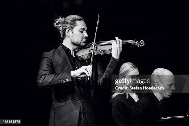 Violinist David Garrett and pianist Julien Quentin perform live on stage during a concert at Philharmonie on March 30, 2015 in Berlin, Germany.