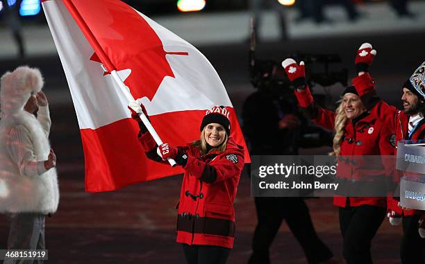 Hayley Wickenheiser of Canada is the flag bearer during the Opening Ceremony of the 2014 Winter Olympic Games at the Fisht Olympic Stadium on...