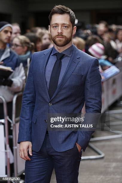 British actor Richard Rankin poses for photographers as he arrives for the 2015 Empire Awards in central London on March 29, 2015. AFP PHOTO / JUSTIN...