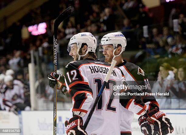 March 27: Portland Pirates Justin Hodgman, left and Alex Bolduc celebrate a second period goal against the St. John's Icecaps Thursday, March 27,...