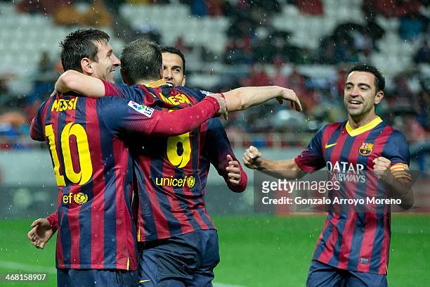 Lionel Messi of FC Barcelona celebrates scoring their third goal with teammates Andres Iniesta , Pedro Rodriguez Ledesma and Xavi Hernandez during...