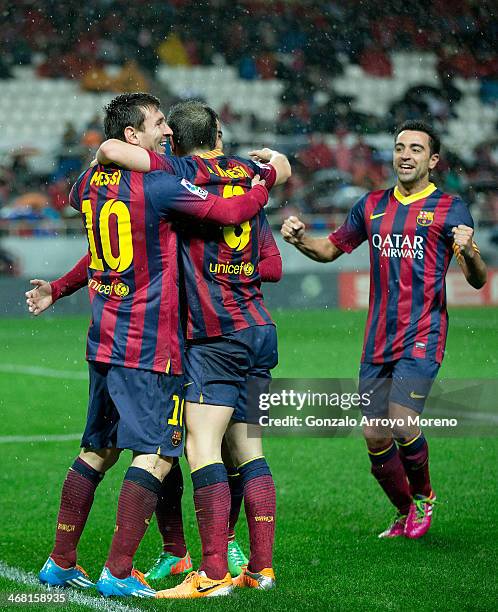 Lionel Messi of FC Barcelona celebrates scoring their third goal with teammates Andres Iniesta , Pedro Rodriguez Ledesma and Xavi Hernandez during...