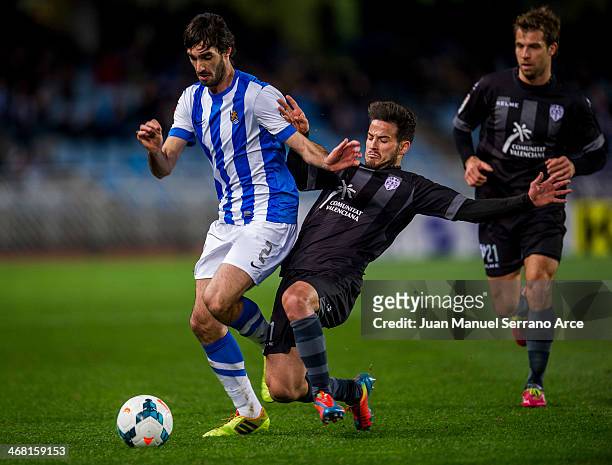 Carlos Martinez of Real Sociedad duels for the ball with Ruben Garcia ofLevante UDduring the La Liga match between Real Sociedad de Futbol andLevante...