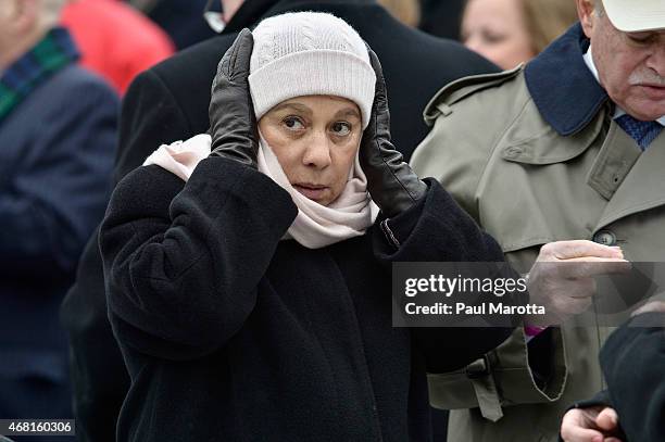 Snow falls as patrons wait in line to pass through security at the Dedication Ceremony at Edward M. Kennedy Institute for the United States Senate on...