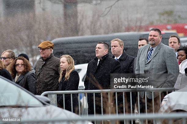 Snow falls as patrons wait in line to pass through security at the Dedication Ceremony at Edward M. Kennedy Institute for the United States Senate on...