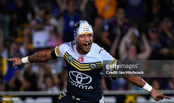 Johnathan Thurston of the Cowboys celebrates after kicking the winning field goal during the round four NRL match between the North Queensland...