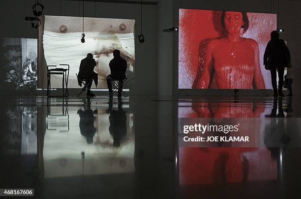 Lifestyle-Austria-art-exhibition,FEATURE Visitors view large screens projecting performances of Otto Muehl and other famous artists known as...