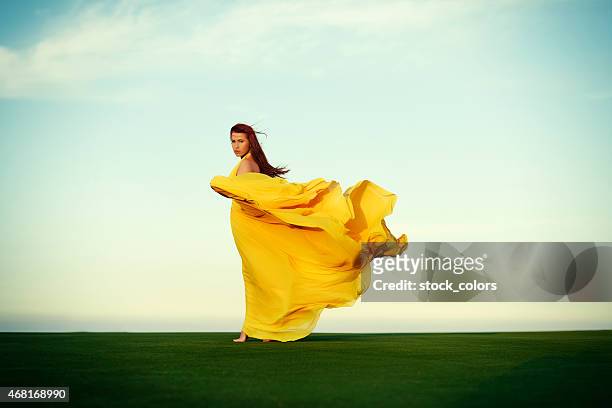 woman walking in the wind - flowing fabric stock pictures, royalty-free photos & images