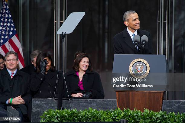 President Barack Obama makes a joke, as Edward Kennedy Jr., First Lady Michelle Obama, and Victoria Reggie Kennedy, right, look on, during an...