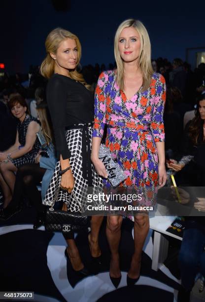Paris Hilton and Nicky Hilton attend the Diane Von Furstenberg fashion show during Mercedes-Benz Fashion Week Fall 2014 at Spring Studios on February...