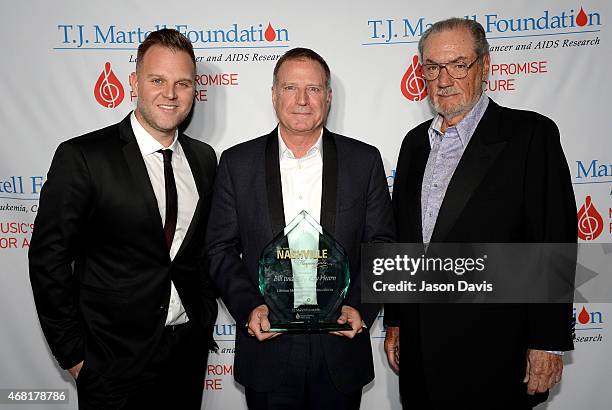 Bill Hearn accepts the Frances Preston Lifetime Music Industry Achievement Award on behalf of his father, Billy Ray Hearn, along with Matthew West...