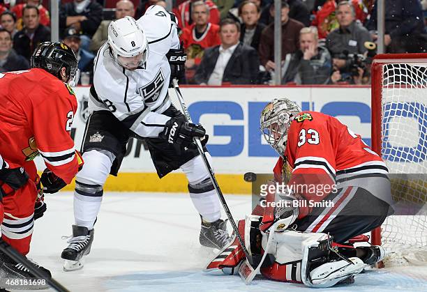 Goalie Scott Darling of the Chicago Blackhawks blocks the shot as Drew Doughty of the Los Angeles Kings attempts the rebound during the NHL game at...