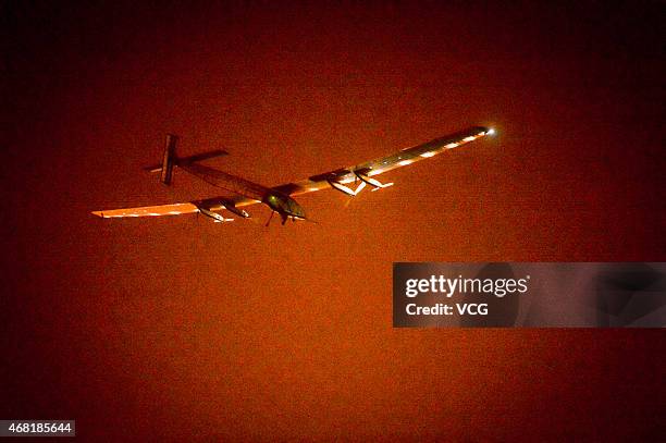 The solar-powered aircraft Solar Impulse 2 prepares to land at Chongqing Jiangbei International Airport early Tuesday on March 31, 2015 in Chongqing,...