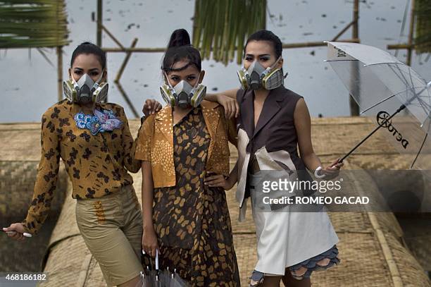 To go with story Indonesia environment water pollution fashion In this photograph taken on March 22, 2015 Indonesian models with gas masks wear...