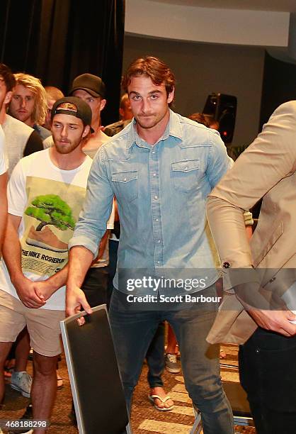 Bombers captain Jobe Watson flanked by his teammates leaves after speaking to the media at the Pullman Hotel on March 31, 2015 in Melbourne,...
