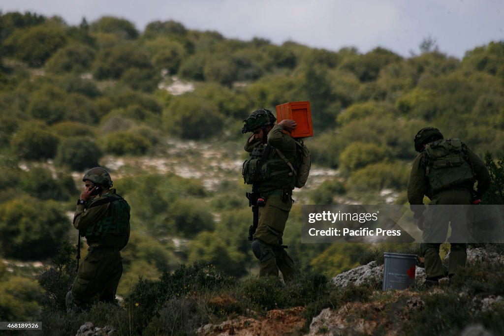 Palestinian protesters hurl stones toward Israeli soldiers...