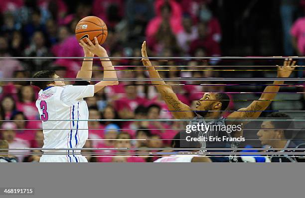 Doug McDermott of the Creighton Bluejays shoots over Mikael Hopkins of the Georgetown Hoyas during their game at CenturyLink Center on January 25,...