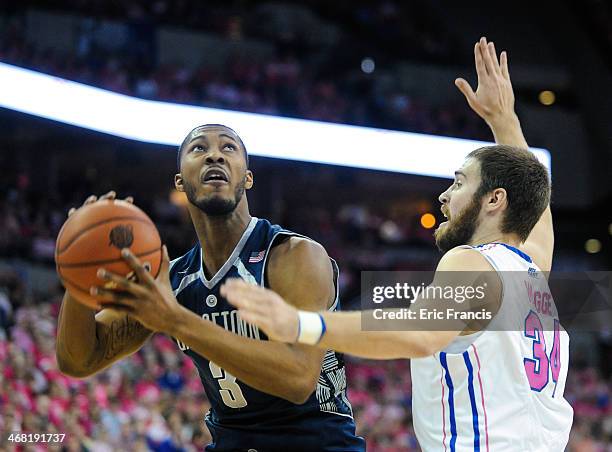 Mikael Hopkins of the Georgetown Hoyas looks over Ethan Wragge of the Creighton Bluejays during their game at CenturyLink Center on January 25, 2014...