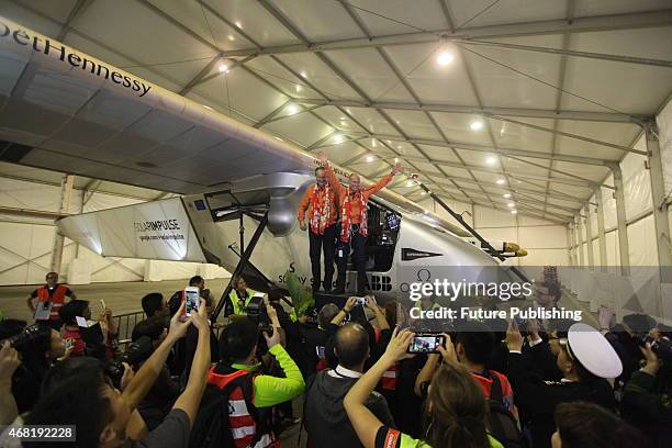 Swiss pilots Andre Boschberg and Bertrand Piccard pose for a photograph as the "Solar Impulse 2", a solar powered plane, arrive at the airport on...
