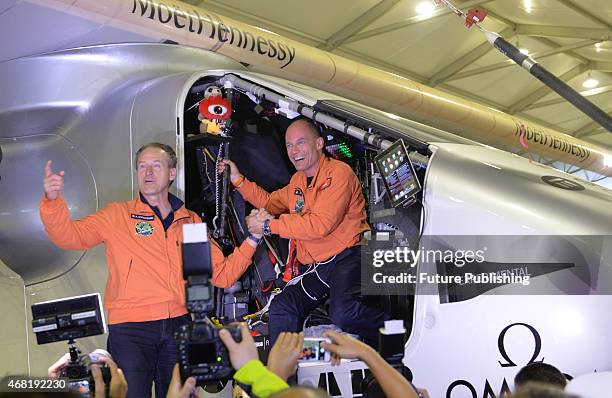 Swiss pilots Andre Boschberg and Bertrand Piccard pose for a photograph as the "Solar Impulse 2", a solar powered plane, arrive at the airport on...
