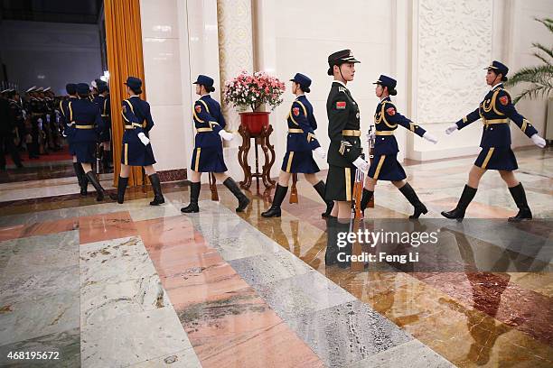 Female members of an honor guard march during a rehearsal before a welcome ceremony for Ugandan President Yoweri Kaguta Museveni at the Great Hall of...