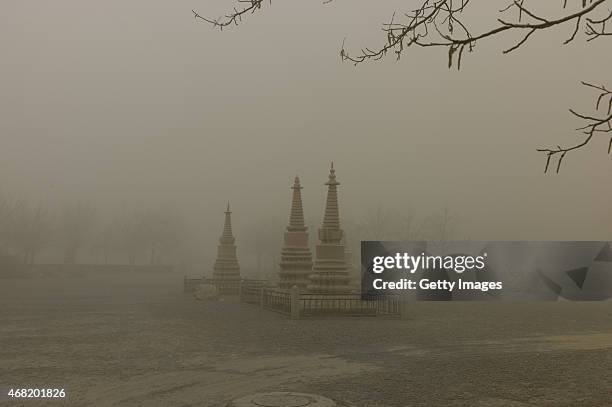 The Mogao Grottoes experience the first regional dust weather of this spring on March 31, 2015 in Jiuquan, Gansu province of China. Sand storm hits...