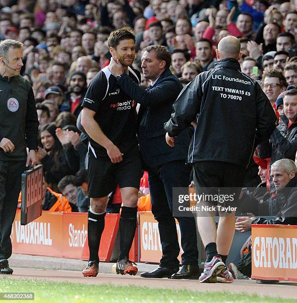 Xabi Alonso and Brendan Rodgers during the Liverpool All Star Charity Match at Anfield on March 29, 2015 in Liverpool, England.