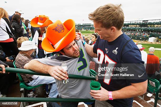 Two football fans pose on the par-three 16th hole during the third round of the Waste Management Phoenix Open at TPC Scottsdale on January 31, 2015...