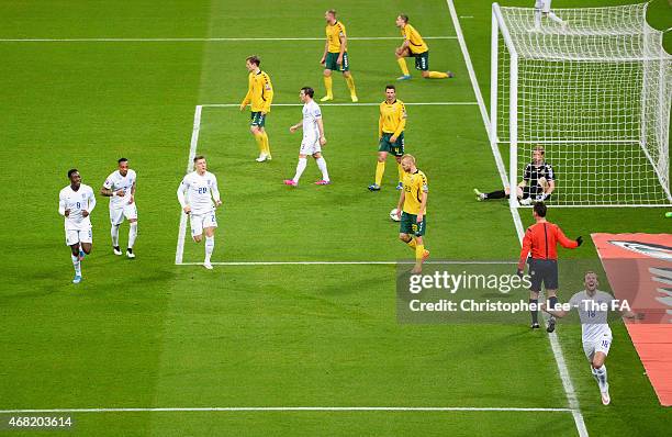 Harry Kane of England celebrates scoring their fourth goal past Giedrius Arlauskis of Lithuania during the EURO 2016 Qualifier between England and...