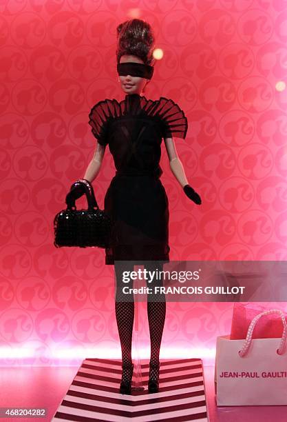 Barbie doll dressed up in a creation of French designer Jean-Paul Gaultier is displayed on April 6, 2009 in Paris during the "Barbie Fashion show...