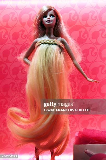 Barbie doll dressed up in a creation of French designer Jean-Charles de Castelbajac is displayed on April 6, 2009 in Paris during the "Barbie Fashion...