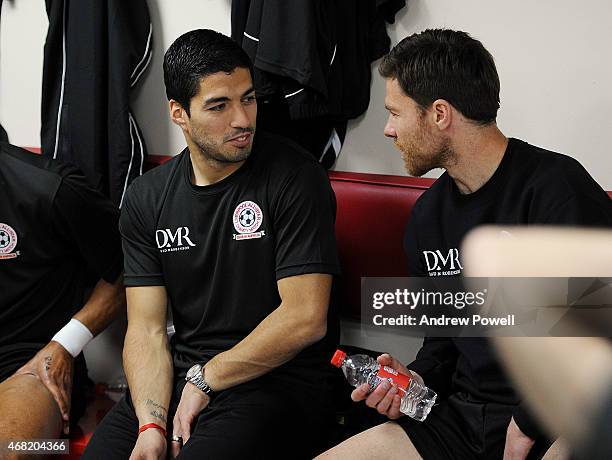 Luis Suarez talks with Xabi Alonso in the dressing room before the Liverpool All Star Charity Match at Anfield on March 29, 2015 in Liverpool,...