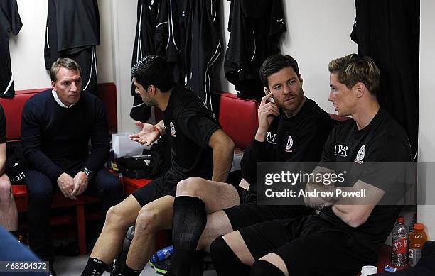 Brendan Rodgers talking with Luis Suarez and Xabi Alsonso talking with Fernando Torres in the dressing room before the Liverpool All Star Charity...