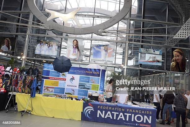 Posters of late French gold medalist swimmer Camille Muffat hang in the entrance of the Limoges swimming pool on March 31 in homage to the champion,...