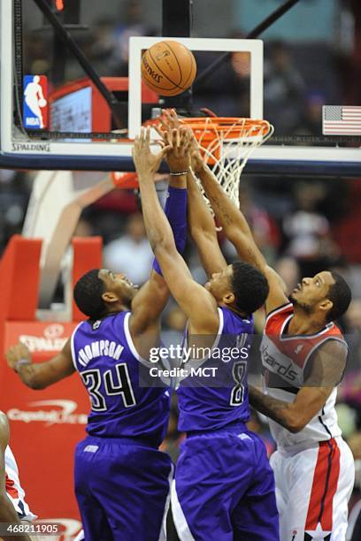 Sacramento Kings power forward Jason Thompson , Sacramento Kings small forward Rudy Gay and Washington Wizards small forward Trevor Ariza fight for a...