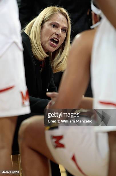Head coach Brenda Frese of the Maryland Terrapins huddles with her players during a timeout in the first half against the Duke Blue Devils during the...