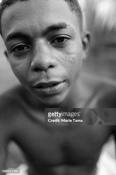 Wellington Vinicius da Silva who is homeless, poses in a park where other homeless gather in the West Zone on March 27, 2015 in Rio de Janeiro,...