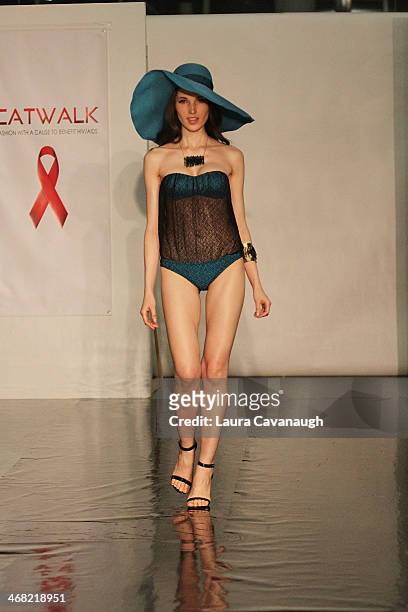 Model walks the runway wearing Caitlin Kelly design at the Hairshion fashion show during Mercedes-Benz Fashion Week Fall 2014 at Alvin Alley Studios...