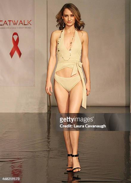 Model walks the runway wearing Caitlin Kelly design at the Hairshion fashion show during Mercedes-Benz Fashion Week Fall 2014 at Alvin Alley Studios...