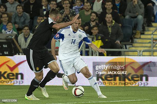 Israel's forward Ben Sahar vies with Belgium's defender Toby Alderweireld during their Euro 2016 qualifying football match match between Israel and...