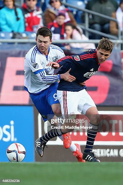 Jack McInerney of Montreal Impact fouls Scott Caldwell of New England Revolution during the second half at Gillette Stadium on March 21, 2015 in...