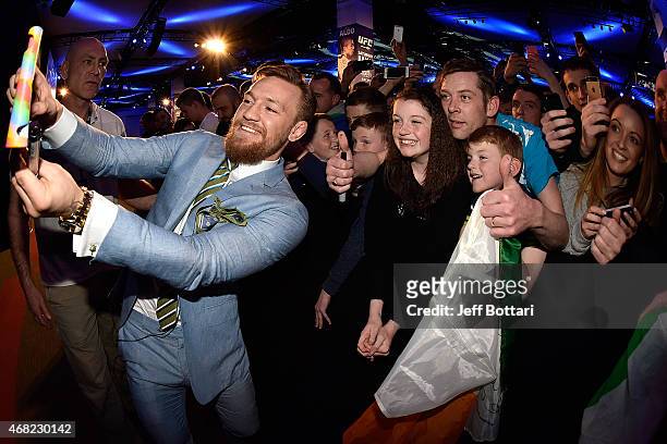 Featherweight title challenger Conor 'The Notorious' McGregor of Ireland interacts with fans during the UFC 189 World Championship Fan Event on March...