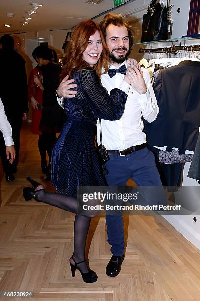 Actress Lou Lesage dancing with a waiter attend the Tommy Hilfiger Boutique Opening at Boulevard Capucines on March 31, 2015 in Paris, France.